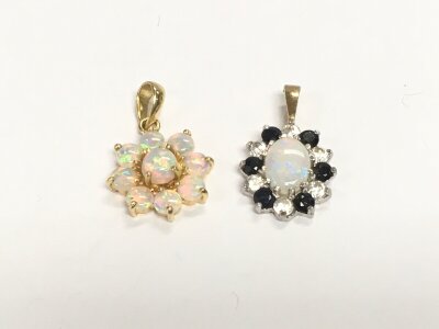 Two opal and gold pendants, total approx
