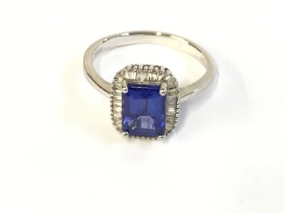 A platinum ring set with emerald cut Tanzanite. Size N 1/2 and 5.33g.
