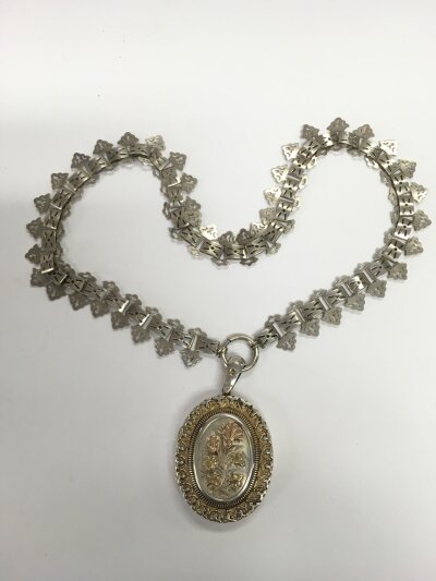 A large silver locket and chain, approx 37g.