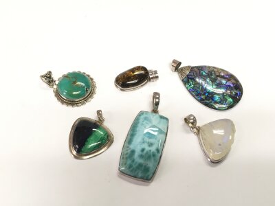 Six various silver pendants, approx 67g.
