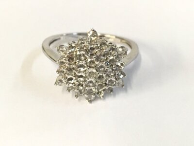 A 14ct white gold diamond cluster ring. Size N 1/2 and 3.66g