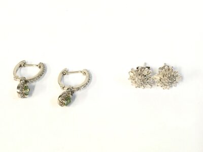 Two pairs of silver earrings.