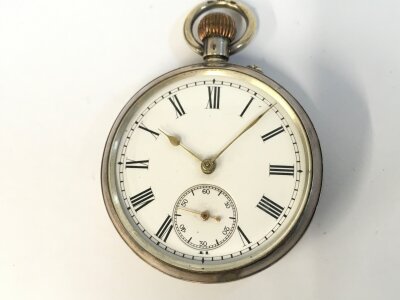 A silver open faced button wind pocket watch. Winds and runs.