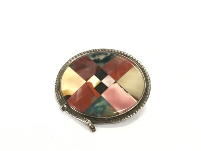 A Scottish checker board stone and white metal brooch, approx diameter 5cm.