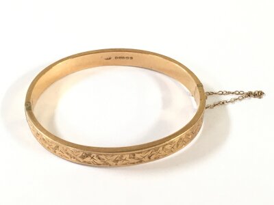 A 9 carat gold bangle, 6cm wide. 8.3G