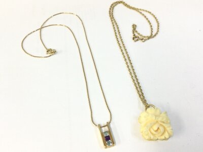 Two 9ct gold necklaces , one with a carved bone flower pendant (2). 8.6g