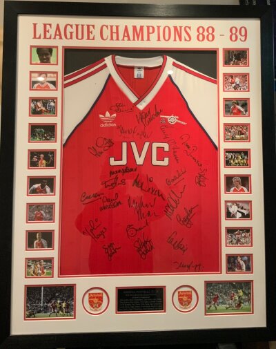 Arsenal 1988 - 1989 League Winners Signed Framed Football Shirt: Stunning framed red short sleeve original Adidas shirt in Attractive 43 x 35 inch frame. Genuine autographs with a few pictures of the team on the famous win over Aston Villa. 22 signatures include Rocastle Davies Adams Merson Smith Winterburn and Groves Full list on plaque under shirt which is pictured online. Nice item with COA from reputable source.