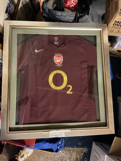 2005/2006 Henry Signed Framed Football Shirt: Redcurrent football shirt signed in black marker by Henry. and dedicated to Bernard. Housed in basic frame and not for sending but can be removed.