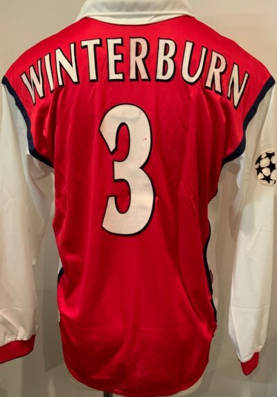 Arsenal Winterburn Match Worn Football Shirt: Red home long sleeve Nike Dreamcast number 3 shirt with Winterburn to rear. Champions League badge to one arm. Worn by player v AIK Solna on 2 11 1999. COA signed by player and photo from the press of him wearing it.