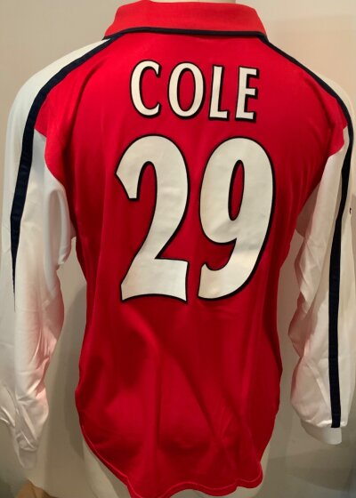 Arsenal Ashley Cole Match Worn Football Shirt: Red home long sleeve Nike Dreamcast number 29 shirt with Cole to rear. Champions League badge to one arm. Worn by Cole v Lyon on 21 2 2001. COA signed by player and photo from the press of him wearing it.
