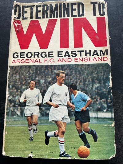George Eastham Arsenal + England Signed Football Book: Book named Determined to Win . Very good condition Stanley Paul book with dust jacket that has tears. and undedicated autographs of both Eastham and Frank McLintock.