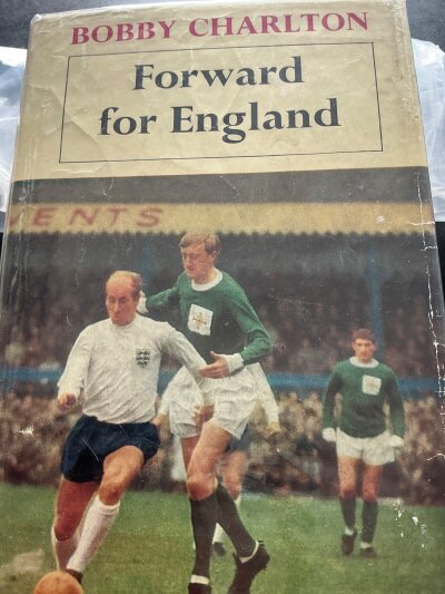 Bobby Charlton Manchester United + England Signed Football Book: Book named Forward for England. Very good condition Pelham book with dust jacket and undedicated autograph.