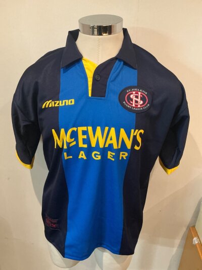 St Helena 1995 - 1996 Home + Away Rugby League Football Kits: Both Mizuno shirts are size 42/44 and unused to include shorts and socks for both kits. C/W a further away shirt in size 38/40 with some other garments. Excellent.