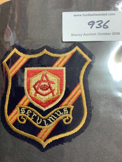 Arsenal Cloth Blazer Football Badge: Large cloth badge we are informed from around the second world war period. Black red and gold background with the emblem in the middle used from the mid 30s to late 40s. The word Servimus prominent which is Latin for we serve. Rare item.
