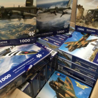 A collection in excess of 20 new unopened Corgi jigsaw 1000 piece puzzles from the aviation archive and Military Legends series. No reserve
