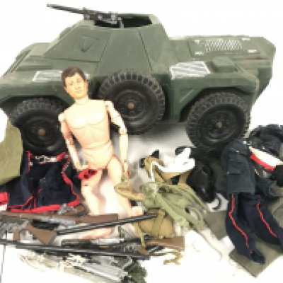 A Box Containing A Action Man with Accessories.