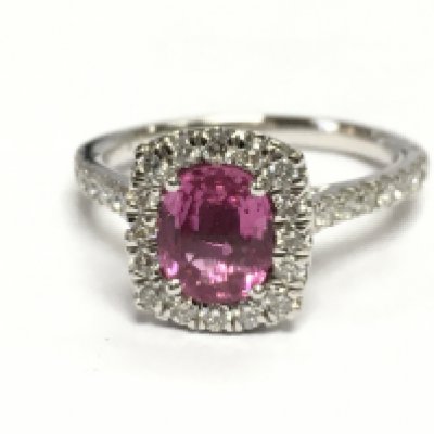 A platnium ring set with an oval pink sapohire surronded by RBC diamonds and diamond set shoulders. Pink sapphires 1.40ct diamonds 0.50ct. Size M weight 5.4g 