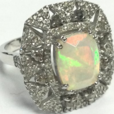 A large ornate silver ring set with a cushion cut opal and diamonds, opal 3.25ct and diamonds 1.10ct 