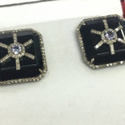 A pair of unusual silver square stud earrings set with black onyx, tanzanite and diamonds, boxed. Onyx 16.05ct diamonds 0.90ct . Round tanzanite 0.25ct 