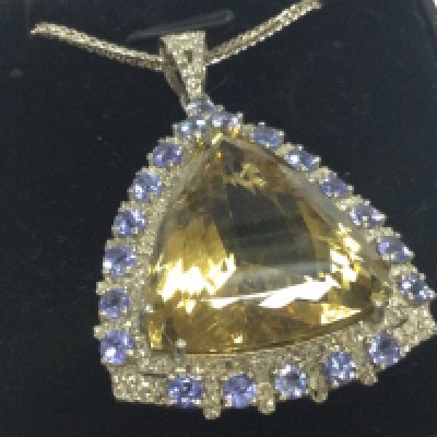 Large silver pendant set with triangle cut citrine , tanzanites and diamonds on a silver chain, boxed. Citrine 20.00ct approx. Tanzanites 2.00ct approx . Diamonds 0.75ct