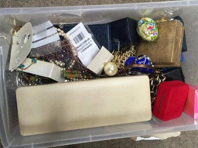 A box of mixed costume jewellery including necklaces, bracelets , brooches etc.