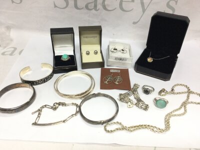 A collection of silver jewellery including bangle bracelets, necklaces, rings etc.