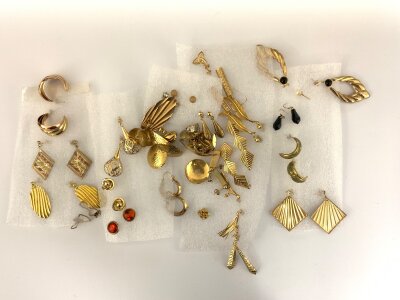 A large collection of gold stud earrings.
