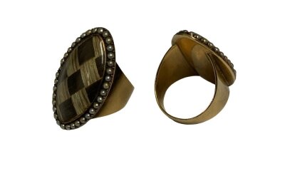An unmarked Victorian yellow metal mourning ring set with woven hair and seed pearls.