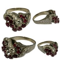 A 1970s heavy 18ct white gold ring set with 0.25ct diamond centre stone and surrounded with small diamonds and rubies. Size M, 8.7g.