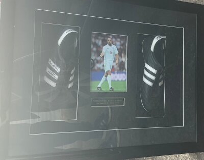 Mathew Upson Match Worn England Framed Adidas Football Boots: Expensively framed in deep frame. Plaque states worn and signed by Matthew Upson. Both boots are signed by the player and are pictured with him wearing them playing for England. Not for posting.