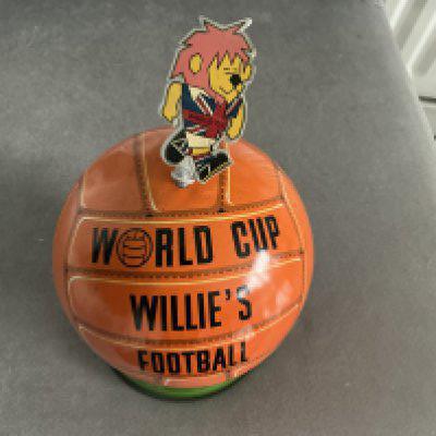 1966 World Cup Willie Lovells Toffee Tin: Stunning toffee tin in very good condition. Seen a few of these and WC Willie is always loose as kids used to open lid with him instead of sliding the join open. When displayed you simply put plaster sine in ball. 