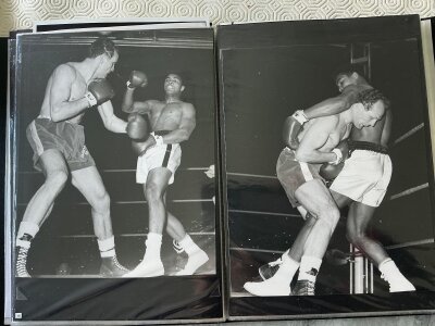 1966 Muhammad Ali v Henry Cooper Boxing Press Photos: Folder containing large photos of the setting up of the ring and seating plus Ali on the scales, fight action and more. C/W magazine pictures. For full list of photos see online pictures. There are 24 photos with 13 being press photos with stamps or annotations. Must view.