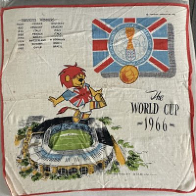 1966 World Cup Football Handkerchief: Large 16 x 16 inch decorative hanky featuring WC Willie, World Cup logo, Wembley Stadium aerial view, previous winners and the FA copyright. 