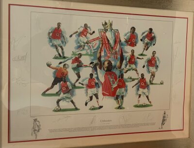 Arsenal Invincibles Signed Framed Football Print: Signed in pencil by the 2003/2004 Championship winning players. Includes Bergkamp Henry Ljungberg Toure Lauren Vieira Campbell Reyes Cole Gilberto Edu Pires Lehmann and the artist Brandham. Framed and glazed measuring 77 x 103cm.