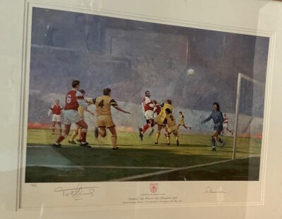 1994 Arsenal ECWC Final Signed Framed Football Print: Attractive print Ltd edition number 32/650 signed by Tony Adams and artist Craig Campbell. Depicts a scene from the final v Palma. Framed and glazed measuring 75 x 64cm.
