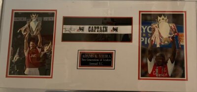 Arsenal Premier League Signed Captains Armband: Signed by Tony Adams and Patrick Vierra. Framed with bevelled mounts. Engraved plaque stating two generations of captains.