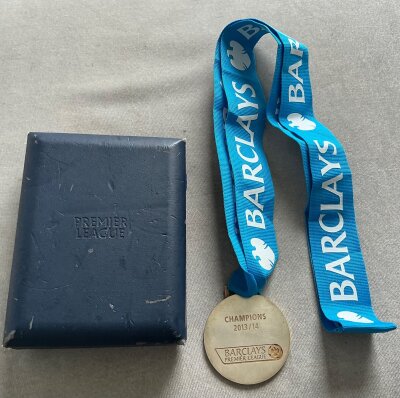 Manchester City 2013 - 2014 Premier League Winners Medal: One of only 40 made and awarded to players,
chairman, secretary and a few back room staff. Premier League to one side the reverse stating Champions
2013/14 with Barclays Premier League logo. Fair condition Premier League box and Barclays lanyard attached to medal.