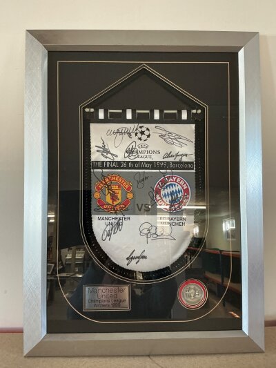 Manchester United Framed Signed Football Pennants: 1999 Champions League winners nicely framed with 13 autographs including Ferguson and Beckham. C/W 2004/2005 season pennant with 9 signatures. Not for posting. (2)