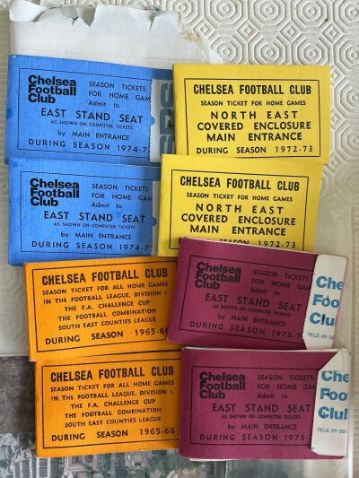Chelsea Football Memorabilia Box:  Often two season ticket books from the 60s and 70s with receipt plus some fixture cards, photos, sew on cloth badges including by maker Coffer and more. Must view.