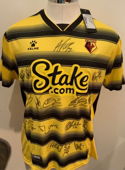 Watford 2021 - 2022 Signed Football Shirt: Yellow and black short sleeve home shirt. Multi Signed to front by 17 of the team. BNWT.
