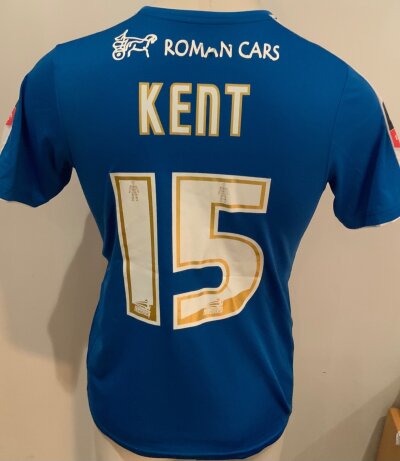 Colchester United 2015 - 2016 Match Worn Football Shirt: Blue and white short sleeve shirt. Number 15 Kent to rear. Match worn v Tottenham in the FA Cup.