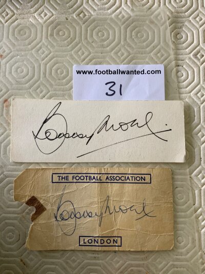 Bobby Moore England + West Ham Football Autographs: England luggage label with creasing one side stating The Football Association London the other having the FA crest which is signed in biro by Bobby Moore. Additionally there is a white card with another undedicated genuine autograph of him. (2)
