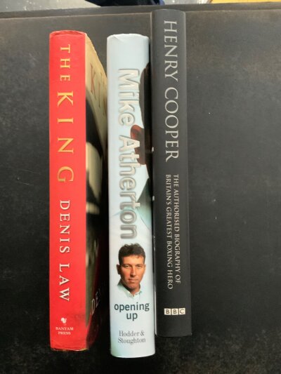 Signed Sports + Football Books: Hardback autobiography hand signed without dedication by Denis Law and a Preston book signed by Tom Finney. C/W Carl Fogarty and Frank Bruno undedicated plus Henry Cooper + Mike Atherton dedicated books. (6)