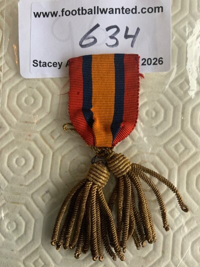 Early 1900s Football Stewards Badge: Red orange and blue cloth pin badge with no writing. We are informed this is a football stewards badge but it is not evident from item.