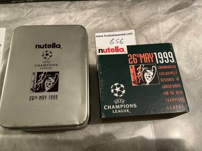 Manchester United 98/99 Champions League Final Boxed Wrist Watch: Champions League logo with Barcelona 99 and date of match to metal box. Chronograph Ltd edition sponsored by Nutella watch which is unused with matching silver coloured strap and a spare leather strap.