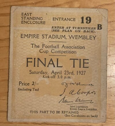 1927 FA Cup Final Football Ticket: Cardiff City v Arsenal  ticket in good condition. C/W autograph of Arsenal goalkeeper Dan Lewis who is unfortunately credited with the own goal and Charles Buchan the Arsenal captain. Also included is a replica programme and later produced booklet of match.