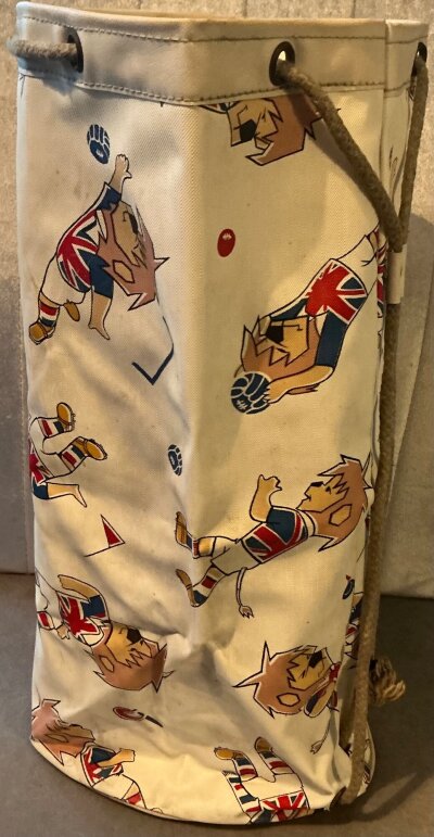1966 World Cup Willie Original Duffel Bag: Excellent condition plastic duffle bag with World Cup Willie in different poses all over the outside. Purchased in 1966 by vendor. Rare item measuring around 40cm high.