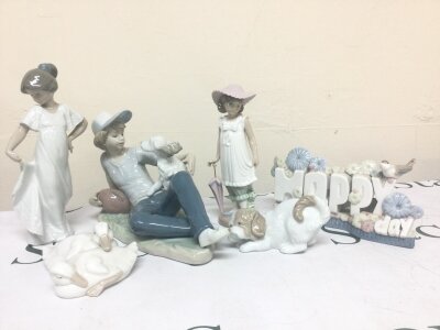 A collection of Nao porcelain figures