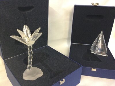 Two boxed Swarovski figures, sailboat and palm tree