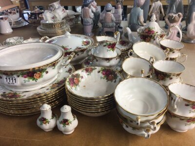 A Royal Albert old English country rose dinner and tea service dinner plates side plate two tureens (one with damaged cover) desert bowls soup bowls cups and saucers. No other obvious damage.